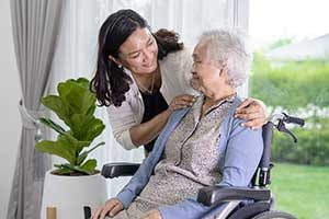 Caregiver With Elderly In Wheelchair