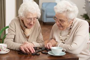 Two Elderly Women Playing Dominos