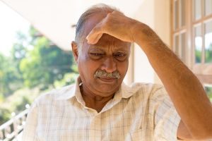 An Elderly Person With A Headache From A Concussion.